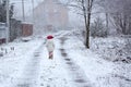 Little girl walking on snowy rural road Royalty Free Stock Photo