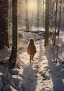 A little girl walks through the snow in the winter forest