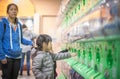 Little girl wanting Toys from Japanese Toys vending machine