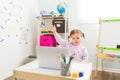 Little girl wants to answer a question during a class via video call Royalty Free Stock Photo