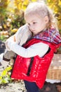 Little girl in warm clothes with toy rabbit Royalty Free Stock Photo