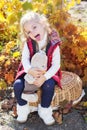 Little girl in warm clothes with toy rabbit Royalty Free Stock Photo