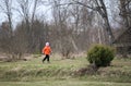 Little girl walks outdoors. Happy child in countryside. Early spring.