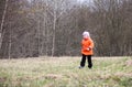 Little girl walks outdoors. Happy child in countryside. Early spring.