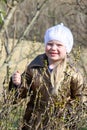 Little girl walks outdoors. Happy child in countryside. Early spring.