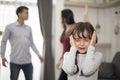 Little girl was crying because dad and mom quarrel, Sad and dramatic scene, Family issued, Children`s Rights abused in Early Royalty Free Stock Photo