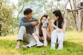 Disappointment girl with parents scolding her in the park