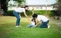 A little girl was slightly injured while playing with her parents comforting her at her side Royalty Free Stock Photo