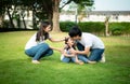 A little girl was slightly injured while playing with her parents comforting her at her side Royalty Free Stock Photo