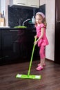Little girl washes floor with a mop Royalty Free Stock Photo