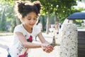 Little girl washes her hands at the tap