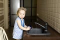 Little girl washing dishes in the kitchen at home Royalty Free Stock Photo