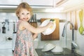 Little girl washing dishes with sponge in kitchen sink at home Royalty Free Stock Photo