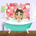 Little girl washing her hair with shampoo sitting in bathtub in bathroom Royalty Free Stock Photo