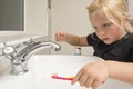 Little Girl Washing Toothbrush Under Running Water in Bathroom S Royalty Free Stock Photo