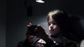 a little girl watches cartoons, plays games on a smartphone at night, in the dark