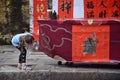 A little girl watches a drawing of chinese general Guan Yu