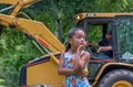 Little girl watches ducks drop at a duck race