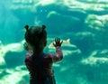Little girl watching fishes in a large aquarium in the Oceanopolis, Brest, France 31 May 2108 Royalty Free Stock Photo