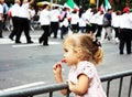 A Little Girl Is Watching A Parade Royalty Free Stock Photo