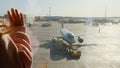 little girl watching Parked plane at the Moscow airport through the gate window. Maintenance and preparation of the