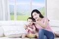 Little girl watching tv with her mother Royalty Free Stock Photo