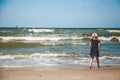 Little girl watching the waves on the beach Royalty Free Stock Photo