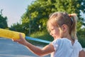 little girl with water gun. Laughing Girl splashing water with a squirt gun Royalty Free Stock Photo