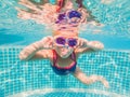 The little girl in the water park swimming underwater and smiling Royalty Free Stock Photo