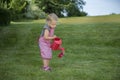 Little girl with watering can in the garden Royalty Free Stock Photo