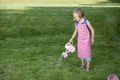 Little girl with watering can in the garden Royalty Free Stock Photo