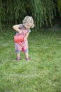 Little girl with watering can in the garden Royalty Free Stock Photo