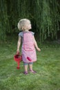 Little girl with watering can in the garden Royalty Free Stock Photo