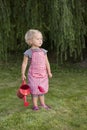 Little girl with watering can in the garden Royalty Free Stock Photo