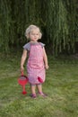 Little girl with watering can in the garden Royalty Free Stock Photo