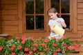 Little girl watering flowers