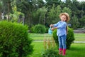 Little girl watering flowers in backyard Royalty Free Stock Photo