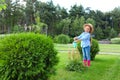 Little girl watering flowers in backyard. Home Royalty Free Stock Photo