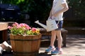 Little girl is watering flowers in the garden/ backyard Royalty Free Stock Photo