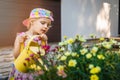 Little girl watering flowers with yellow watering can Royalty Free Stock Photo