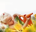 Little girl watering grass