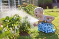 Little girl watering plants in the garden Royalty Free Stock Photo