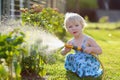 Little girl watering plants in the garden Royalty Free Stock Photo
