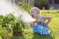 Little girl watering plants in the garden Royalty Free Stock Photo