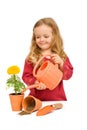 Little girl watering potted flower