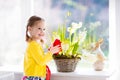 Little girl watering spring flowers Royalty Free Stock Photo