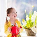 Little girl watering spring flowers Royalty Free Stock Photo