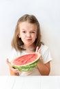 A little girl is a watermelon, croaks, laughs, humor, emotions, eat watermelon