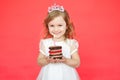 Little girl wearing crown holding a birthday cake Royalty Free Stock Photo