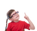 little girl wearing glasses and pointing by forefinger to somewhere up Royalty Free Stock Photo